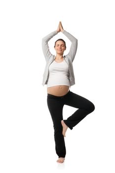 Beautiful pregnant woman smiling and doing exercises isolated