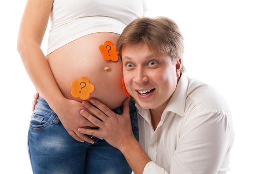 Husband listening to his wife's belly isolated over white