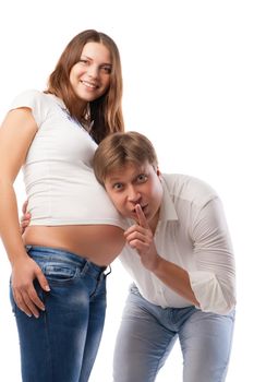 Husband listening to his wife's belly isolated over white