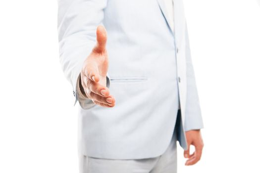 Close up of businessman wearing light suit extended his hand to handshake isolated on white background