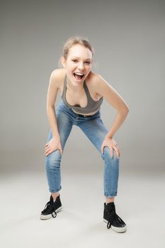 Portrait of young blonde girl with open mouth looking at camera