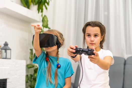 two little girls playing video games virtual reality glasses