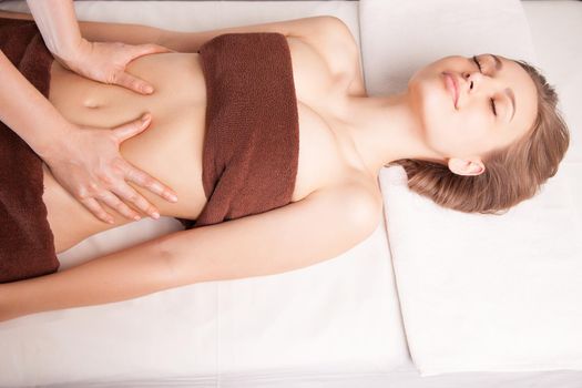 Woman enjoying a Ayurveda oil massage treatment in spa