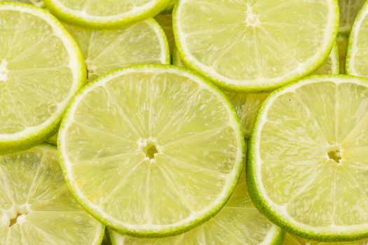 Green background with citrus-fruit of lime slices