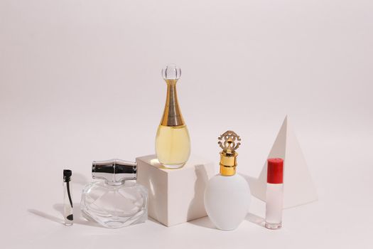 perfume bottle on the neutral modern background. perfect smell for her, woman present