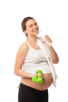 Sportive pregnant girl lifting dumbbells isolated on white background, workout indoors, sport for expectant female, healthy pregnancy concept