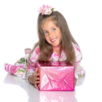 Beautiful little girl with a gift on a white background. Concept of a holiday, New Year and Christmas. Isolated.