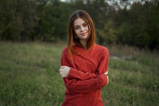 woman red sweater cool air nature romance. High quality photo