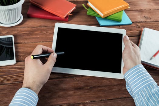 close-up of men's hands with a computer tablet. Businessman works in the office