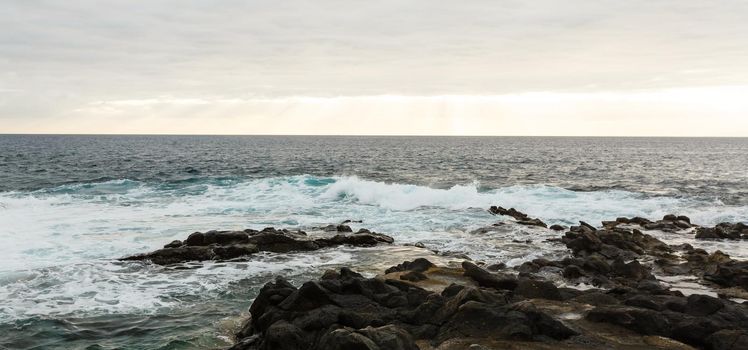 Calm ocean in the morning. ocean shore with stones.