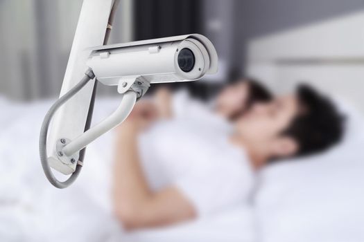 CCTV Camera or surveillance operating with couple sleeping in bedroom