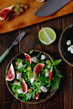Flat view of fig salad with arugula and goat cheese.