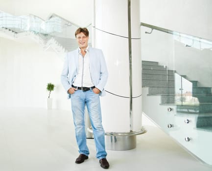 Portrait of handsome smiling business man in urban setting