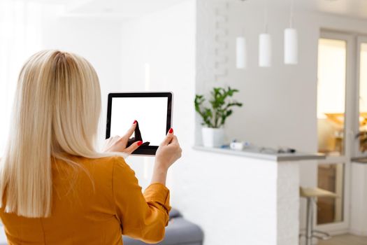 Business woman holding blank touch screen device.