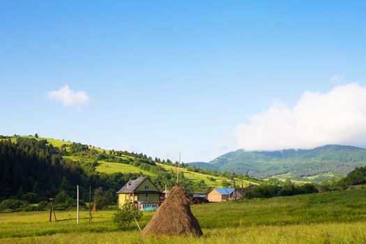 Haystack summer in the beautiful village Ukrainian Carpathians