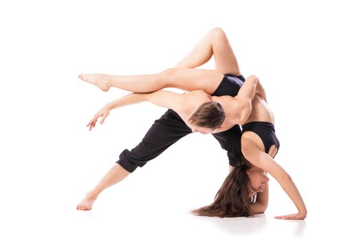 Acrobatic dancing pair doing hard pose. Isolated horizontal studio shot