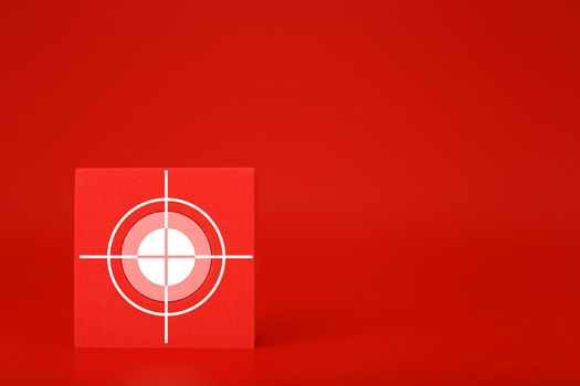Goal symbol on red toy cube on saturated red background with copy space. Concept of goal, success, reaching business and personal aims