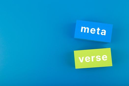 Meta verse modern minimal concept in blue colors. Written metaverse single word on two pink rectangles against dark blue background. Future computer technologies.