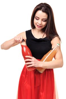 Happy woman comparing two juices isolated on white background. Brunette opens tomato juice