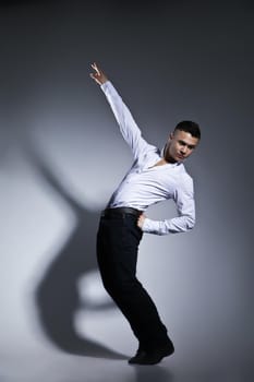 Modern style dancer posing on grey studio background