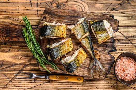 Grilled cut mackerel fish on cutting board. wooden background. Top view.
