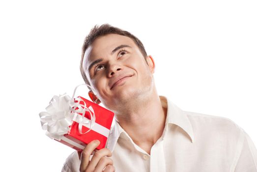 Close-up portrait of smiling man holding gift isolated on white background