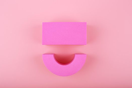 Creative flat lay with happy smile symbol made of figures on bright pink background with copy space. Concept of Smile day, emotions, emoji or mental health