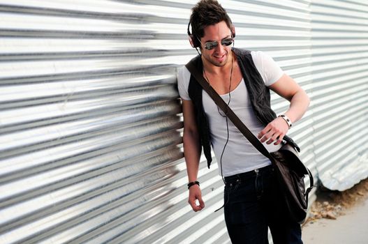 Portrait of young happy man smiling in urban background