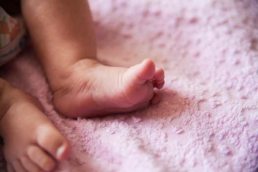 a little baby feet, close up on purple