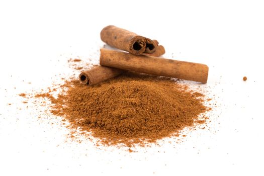 cinnamon powder with sticks isolated on a white background