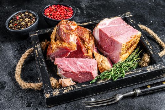 Smoked Sliced Pork Slab Bacon Meat in a wooden tray. Black background. Top view.