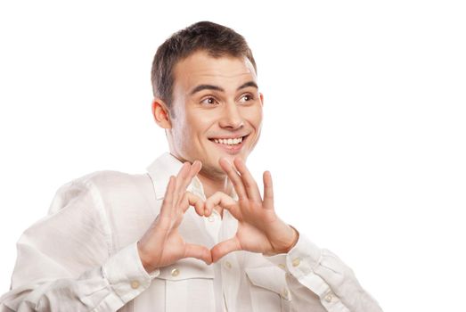 Portrait of happy man making heart from his hands on white background