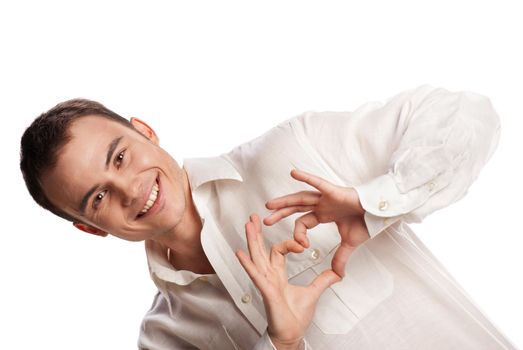 Portrait of happy man making heart from his hands on white background