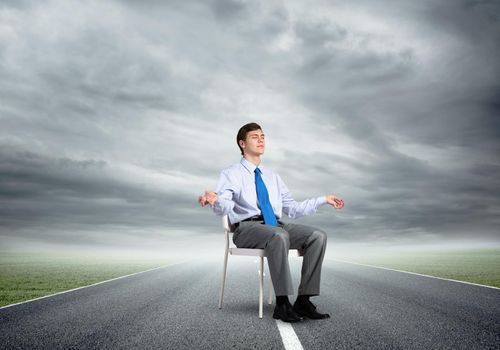 businessman sitting on an office chair, meditation and calmness