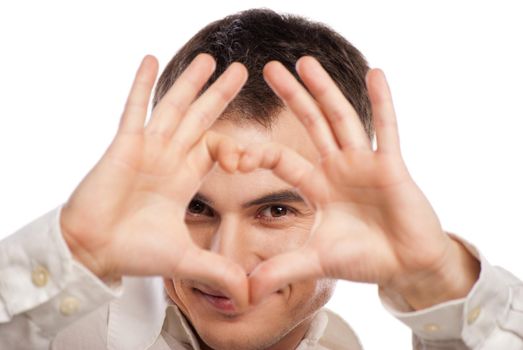 Portrait of happy man making heart from his hands on white background