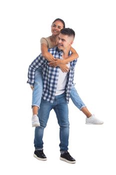 Young male carrying his girlfriend piggyback isolated on white background