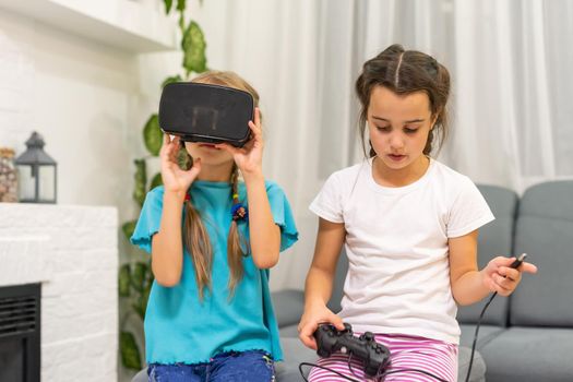 two little girls using glasses of virtual reality headset. concept of modern technologies