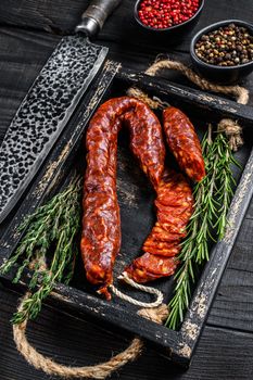 Sliced chorizo salami, Spanish traditional chorizo sausage. Black wooden background. Top view.