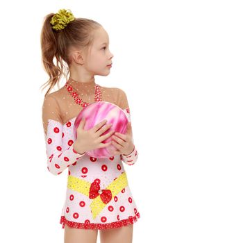 Beautiful little girl gymnast dressed in sports suits for competition, performs exercises with the ball.Isolated on white background.