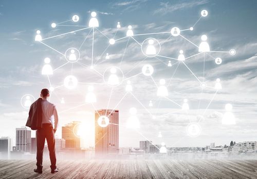 Back view of businessman looking at modern cityscape and connection concept
