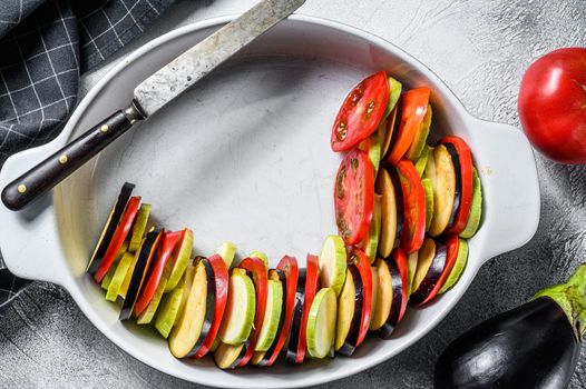 Cooking of Ratatouille - traditional French Provencal vegetable dish. Gray background. Top view.