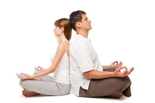Young healthy couple in yoga position on white background