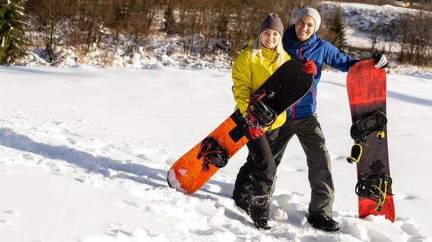 family with snowboards at winter resort