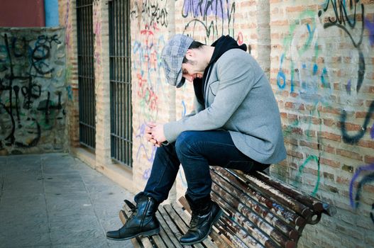 Portrait of handsome man in urban background wearing a retro cap and smiling