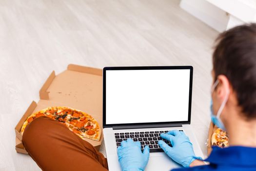 Back view of male person sitting front open laptop computer with blank empty screen for your information or content, modern businessman working in internet