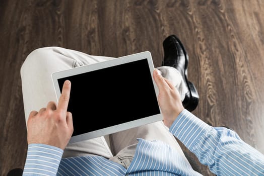 close-up of men's hands with a computer tablet. Businessman works in the office