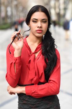 Portrait of hispanic businesswoman in urban background
