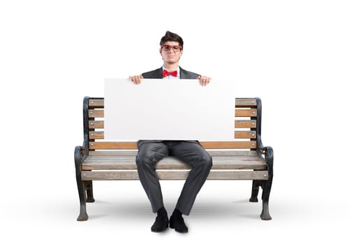Young businessman holds a large white banner. sits on the bench
