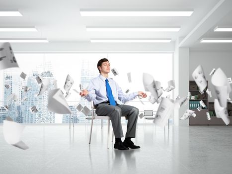 young businessman in the office meditates. concept of creativity