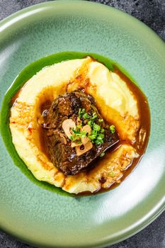 Beef fillet steak with mashed potatoes. Black background. Top view.